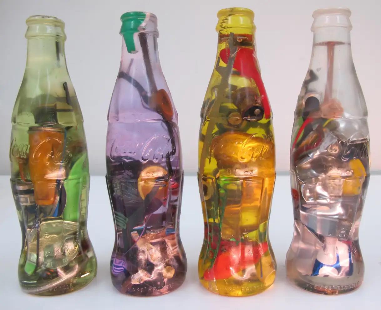 Luis Perelman, "Coca Cola Series," 1998, 21 parts; found materials embedded in clear resin, 7 ½ x 2 ¼ x 2 ¼, Courtesy of Luis Perelman.